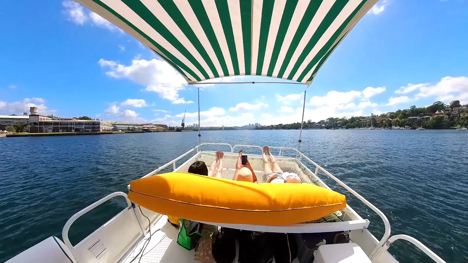 The yellow beanbag and trampoline sunbed under Capri's striped canopy, looking out over Iron Cove