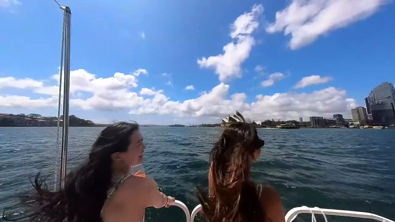 Two guests looking back from Capri's rear couch, hair in the wind