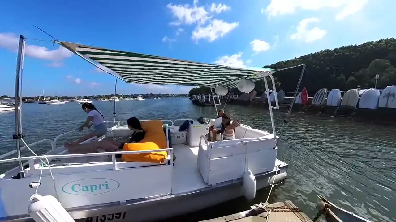 Capri tied up at the Lilyfield wharf before a hire, canopy up